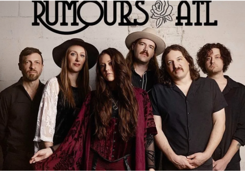 A band called Rumours At posing in front of a wall with their name and a rose illustration, dressed in vintage-inspired outfits.