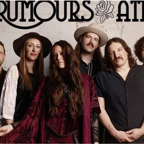 A band called Rumours At posing in front of a wall with their name and a rose illustration, dressed in vintage-inspired outfits.