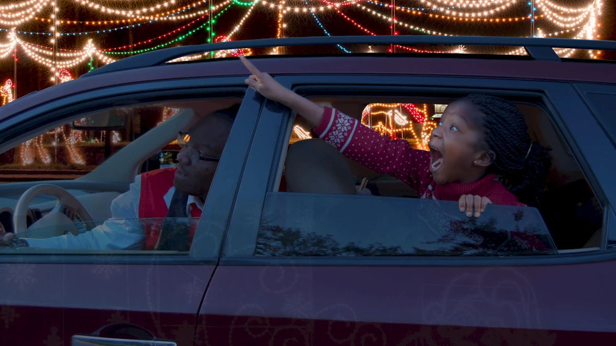 Child Points Excitedly at Light Displays During Magical Nights of Lights at Lanier Islands Resort