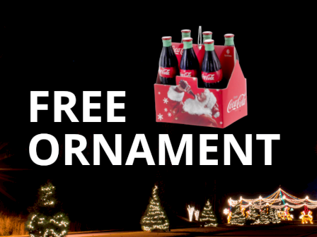 This image shows a six-pack of Coca-Cola bottles with a Santa design, labeled 