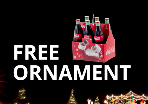 Free ornament: a 6-pack of Coca-Cola bottles in a red carrier, advertised against a dark festive scene.