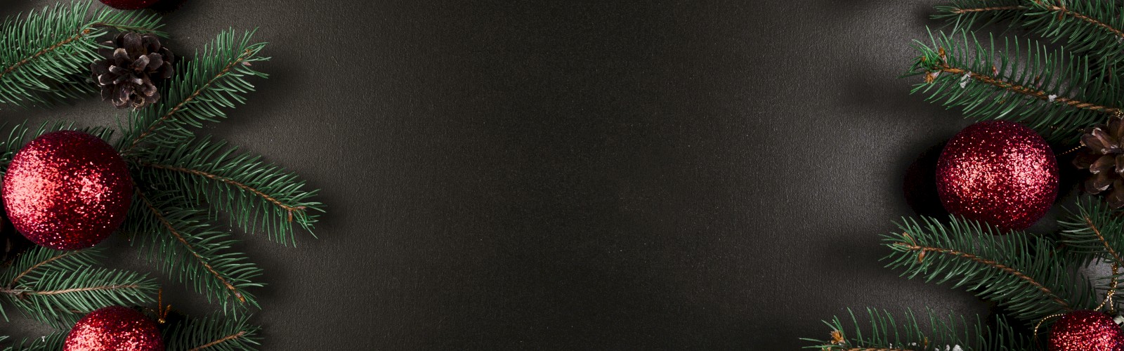 Festive border with red glittery ornaments, pine branches, and pinecones on a dark background.